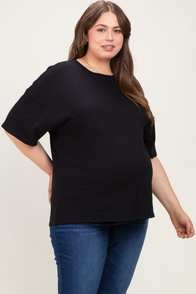 woman wearing a black maternity plus t-shirt and showing her baby bump with blue jeans