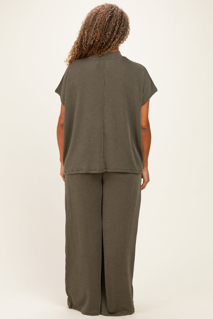 woman wearing a dark olive green short sleeve plus size top and matching wide leg pants, viewed from the back