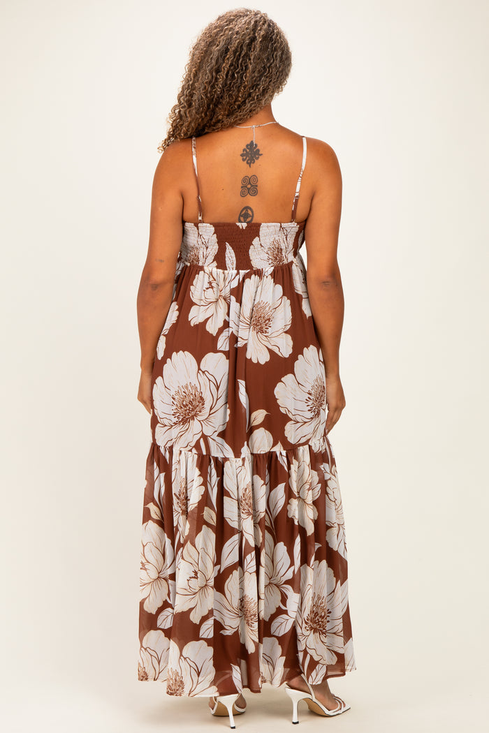 woman wearing a brown floral maxi dress with a smocked bodice and spaghetti straps, showing the back view