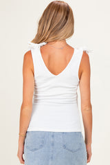 woman wearing a white maternity tank top with v-neck and tie details on the shoulders