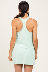 woman wearing a light mint green athletic tank dress with a racerback style