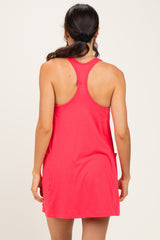 woman wearing a coral pink sleeveless dress with a relaxed fit and side pockets, viewed from the back