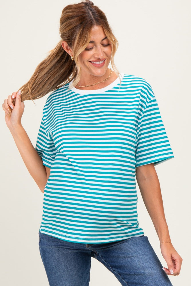 woman wearing a teal and white striped maternity t-shirt with a relaxed fit and denim jeans