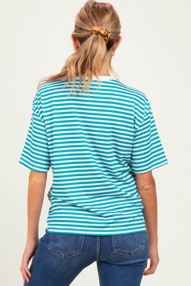 woman wearing a blue and white striped maternity top and dark blue jeans, showing her back