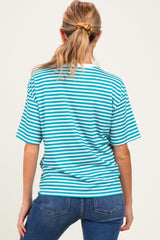 woman wearing a blue and white striped maternity top and dark blue jeans, showing her back