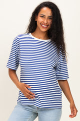 woman wearing a navy and white striped maternity t-shirt and holding her baby bump