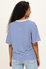woman wearing a blue and white striped maternity top, facing away, with curly hair and casual denim jeans