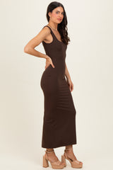 woman wearing a brown fitted maxi dress with thin straps and high heels