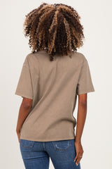 woman wearing a taupe oversized maternity t-shirt and blue jeans, showing the back view