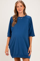 woman wearing a navy blue maternity dress with short sleeves and a relaxed fit, showcasing a baby bump