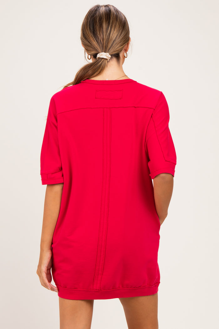 woman wearing a bright red maternity dress with short sleeves and a relaxed fit