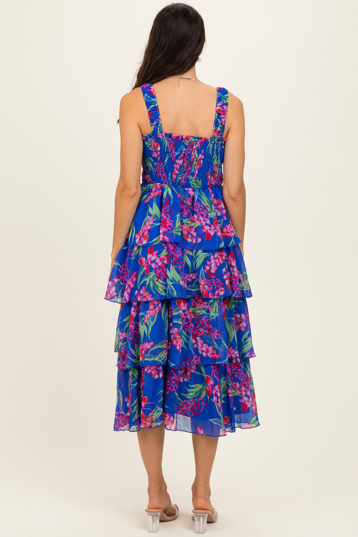 woman wearing a blue floral tiered midi dress with smocked back straps