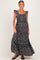 woman wearing a black floral maternity maxi dress with ruffled sleeves and a square neckline