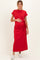 woman wearing a red short sleeve maternity maxi dress and holding her baby bump