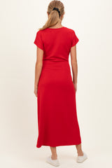 woman wearing a red maternity maxi dress from the back with short sleeves and a fitted silhouette
