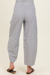 woman wearing striped maternity pants with a relaxed fit and elastic waistband, viewed from the back