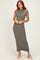 woman wearing a fitted olive green ribbed maxi dress with cap sleeves and a stylish hemline