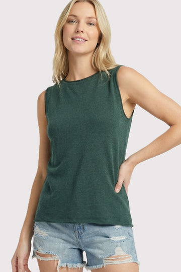 woman wearing a dark green sleeveless top with a relaxed fit and distressed denim shorts