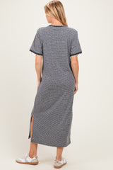 woman wearing a navy and white striped maternity maxi dress with side slits and short sleeves