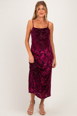 woman wearing a burgundy floral print maternity dress with spaghetti straps and a fitted silhouette