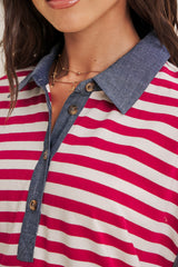 close-up of a woman wearing a red and white striped polo shirt with a denim collar and button details