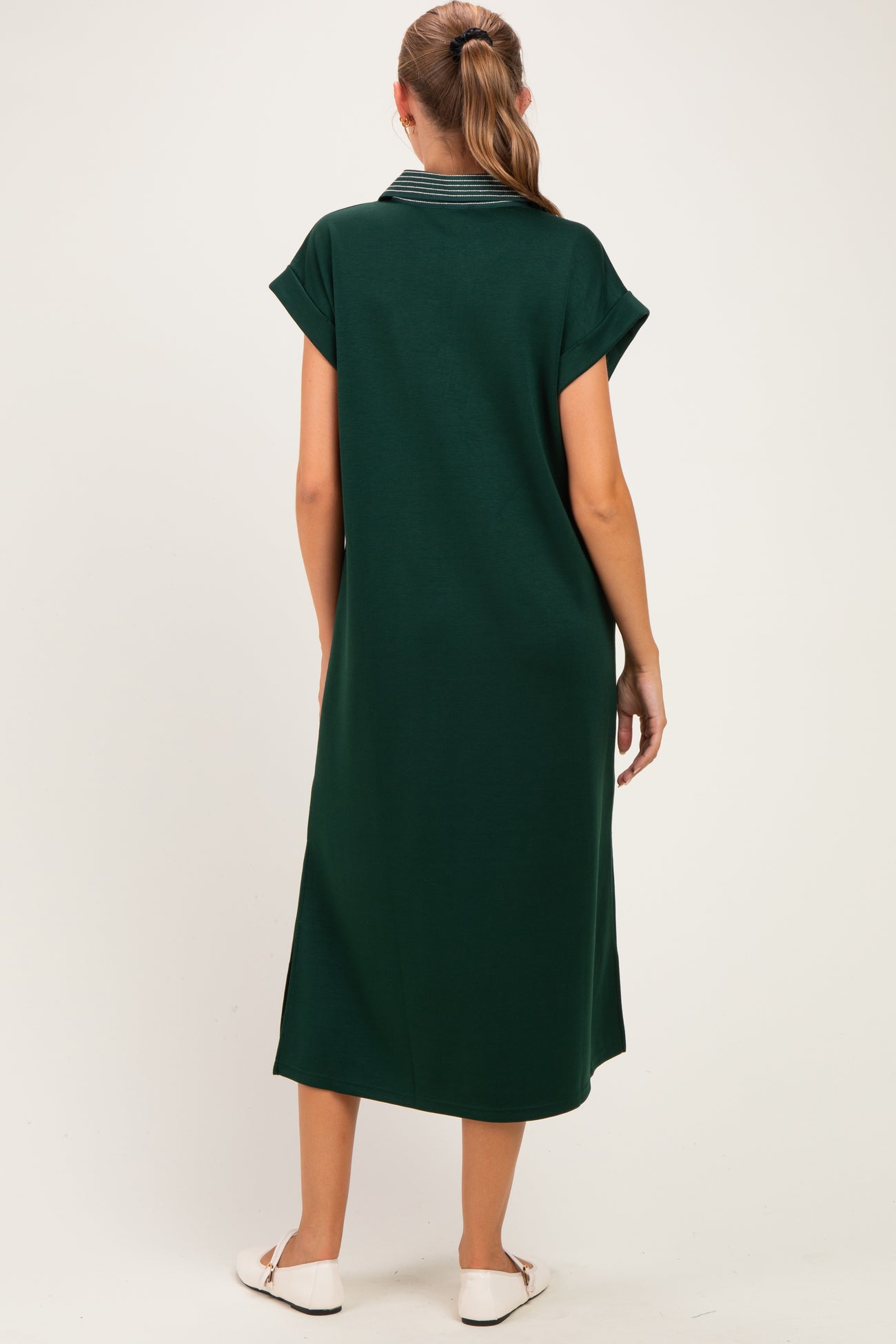 woman wearing a green maternity maxi dress with short sleeves and a striped collar, seen from the back