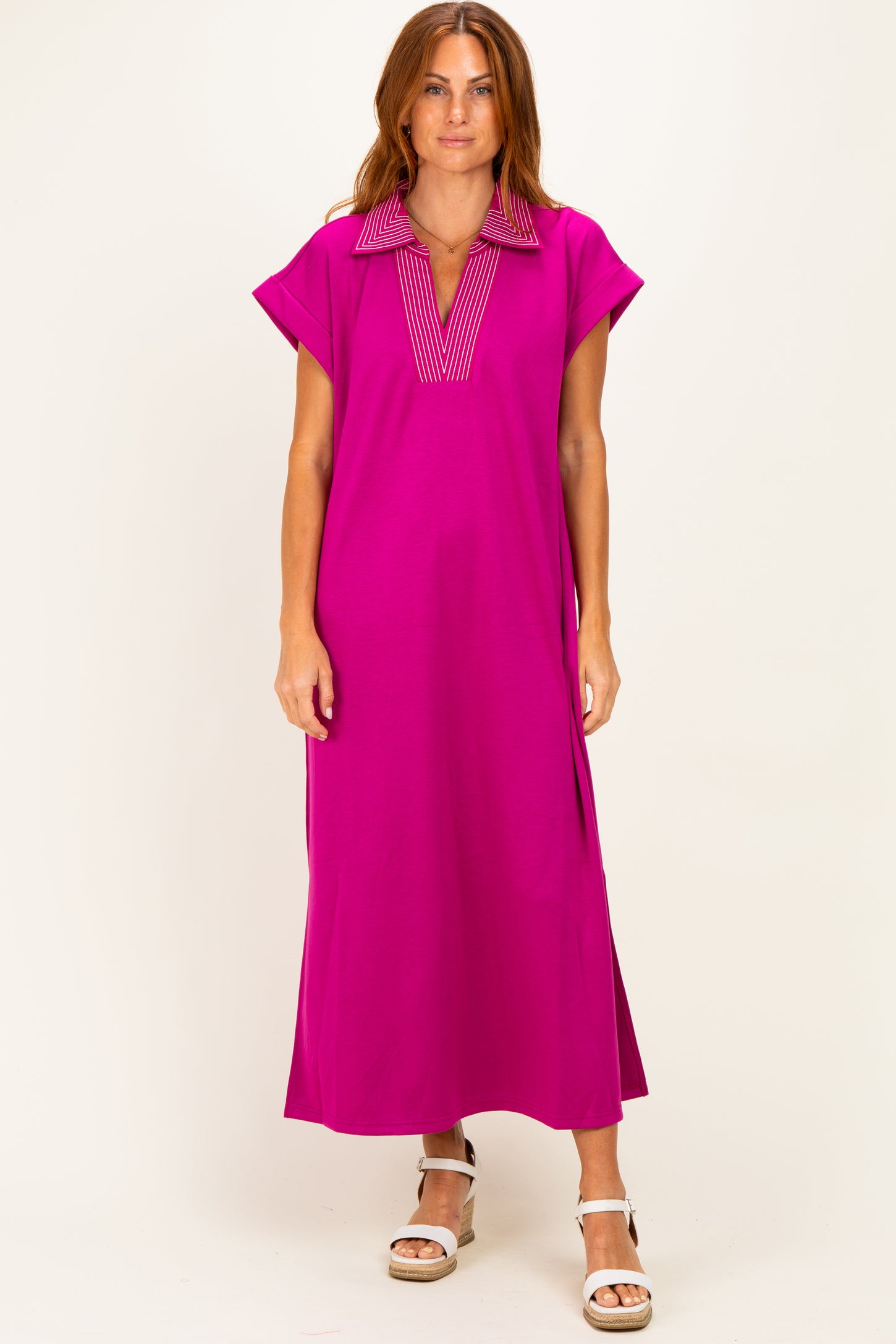 woman wearing a fuchsia maxi dress with a striped collar and short sleeves