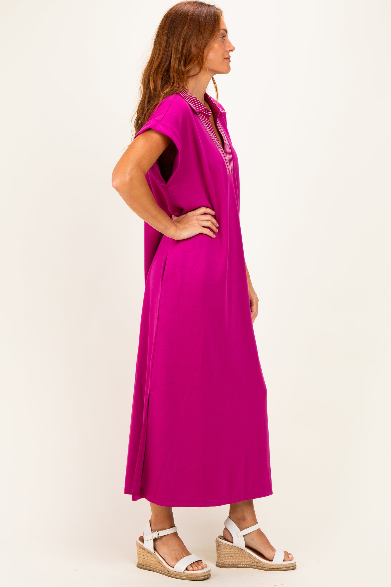 woman wearing a hot pink midi dress with short sleeves and a collar, styled with white wedge sandals