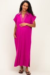 woman wearing a bright pink maternity dress with a striped collar and pockets, showing her baby bump
