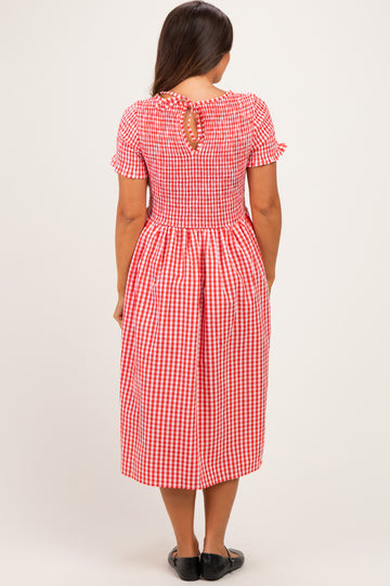 woman wearing a red and white gingham maternity dress with short sleeves and a keyhole back