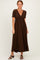 woman wearing a brown short sleeve maxi dress with a v-neck and smocked waist detail