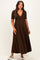 woman wearing a brown short sleeve maternity maxi dress with a v-neck and a cinched waist, showcasing her baby bump