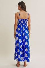 woman wearing a blue floral maxi dress with thin straps and a smocked back