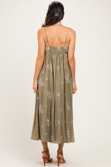 woman wearing an olive green floral midi dress with adjustable spaghetti straps, showing the back view
