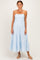 woman wearing a light blue tiered maxi dress with adjustable spaghetti straps and a fitted bodice