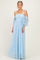 woman wearing a light blue off-the-shoulder lace maxi dress with bell sleeves and a fitted bodice