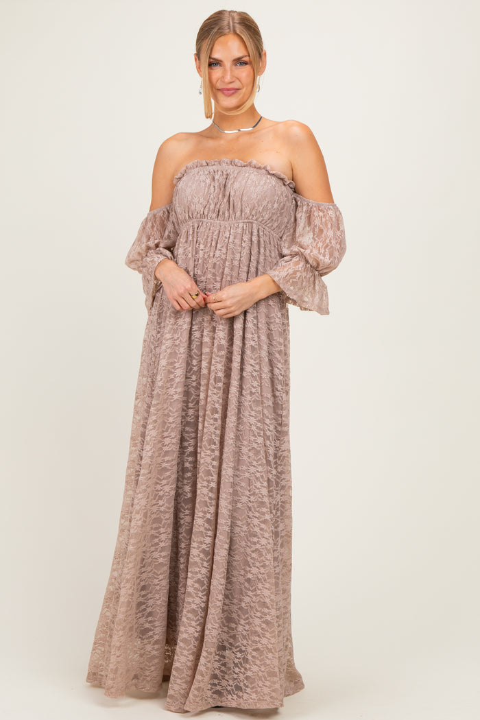 woman wearing a strapless blush maxi dress with ruffled off-the-shoulder sleeves and textured fabric.