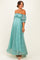 woman wearing a light teal off-the-shoulder lace maternity dress, showcasing her baby bump