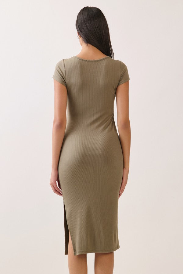 woman wearing a fitted olive green ribbed midi dress with short sleeves and a side slit, shown from the back