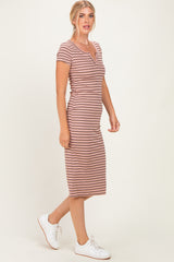 woman wearing a pink and white striped midi dress with short sleeves and a fitted silhouette