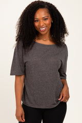 woman wearing a dark gray short sleeve top with a relaxed fit and scoop neckline