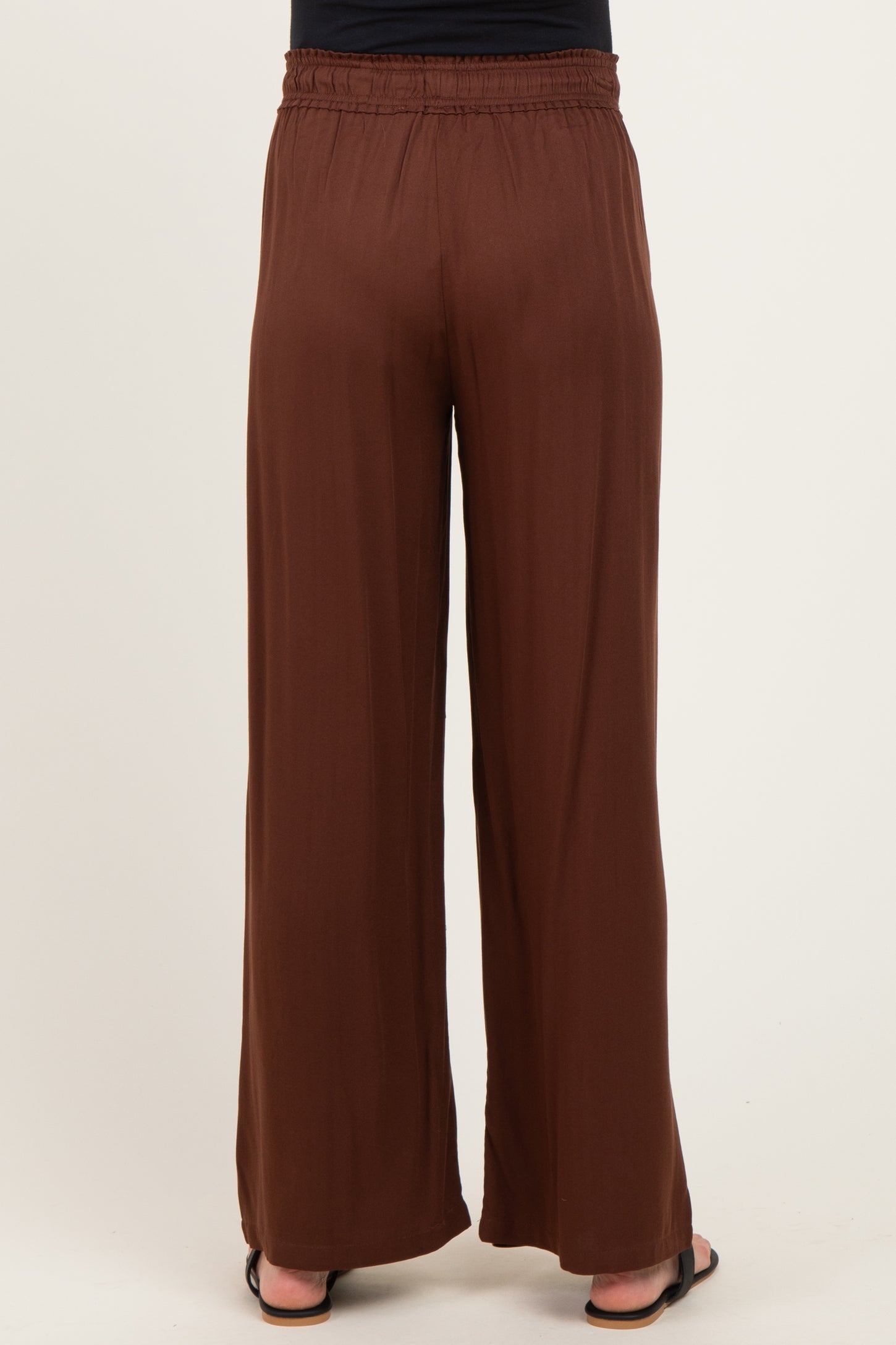 maternity wear brown wide leg pants with an elastic waistband, model not visible from the front