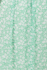 green floral print midi dress with a relaxed fit and subtle pleating details