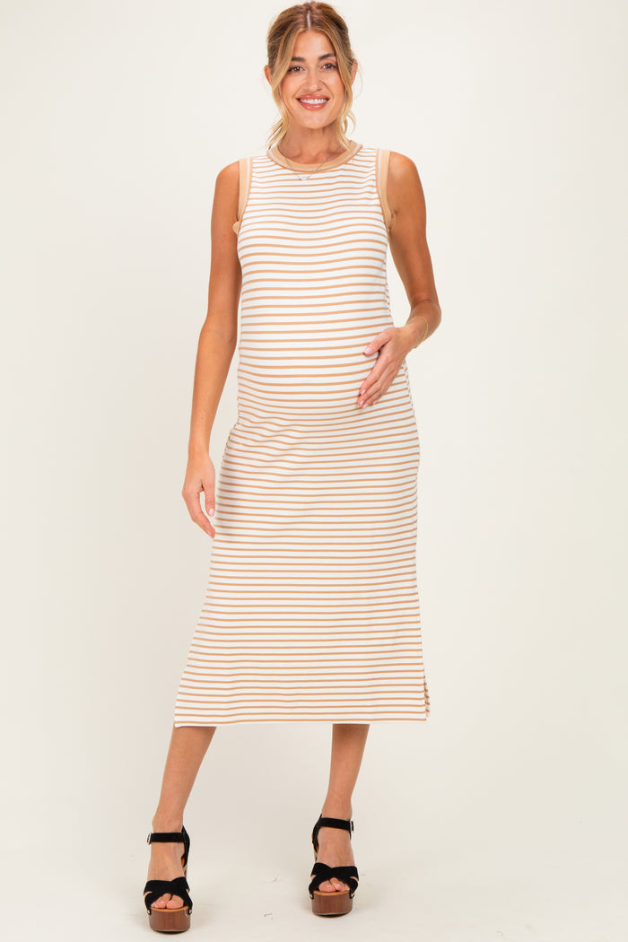 woman wearing a striped maternity dress with a fitted silhouette and a visible baby bump, standing and posing