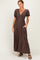 woman wearing a brown polka dot maxi dress with puff sleeves and pockets