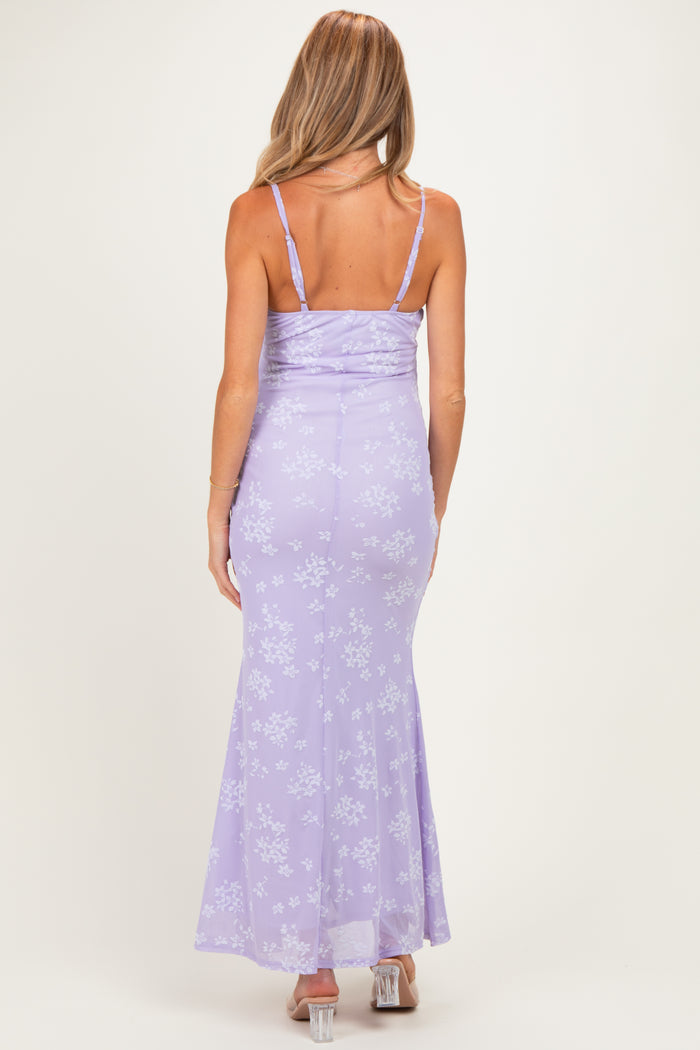 woman wearing a lavender floral print maternity dress with a fitted silhouette and adjustable spaghetti straps