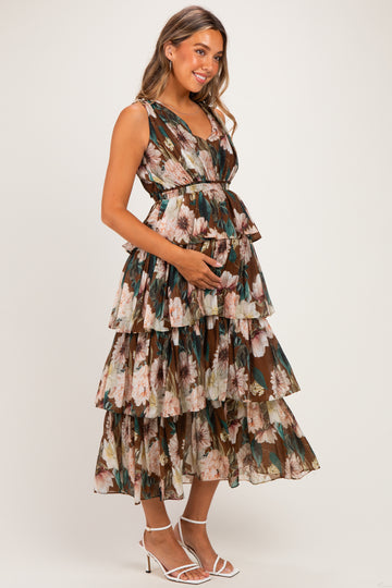 woman wearing a floral print maternity maxi dress with tiered layers and a baby bump visible