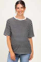 woman wearing a black and white striped maternity top with short sleeves and a relaxed fit, baby bump visible
