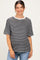 woman wearing a black and white striped maternity top with short sleeves and a relaxed fit, baby bump visible