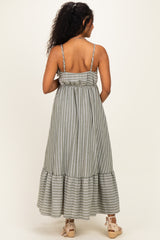 woman wearing a green and white striped maternity maxi dress with spaghetti straps and a ruffled hem
